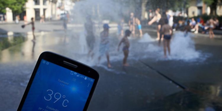 Crianças brincam em fonte pública de Toulouse, na França, quando no verão de 2019 a temperatura atingiu os 39 ºC