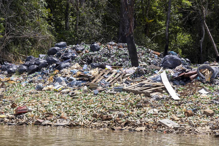 Lixo acumulado às margens do rio Maroni, entrada para a amazônia na Guiana Francesa onde atua o garimpo brasileiro ilegal, que altera a realidade do território