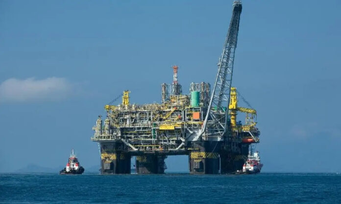 Plataforma de perfuração offshore ao entardecer sobre o oceano, como a prevista na bacia da Foz do Amazonas.