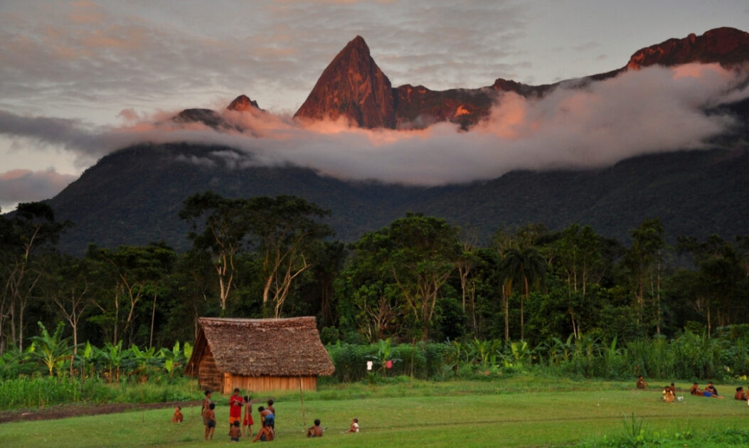 Vista da Aldeia Yanomami do Marari com a Serra Aramamisi ao fundo, representando o território e a importância dos povos indígenas na proteção da Amazônia.