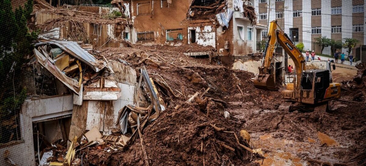 Rua com destroços na Zona da Mata de Minas Gerais após enchentes destaca falhas na infraestrutura do clima.