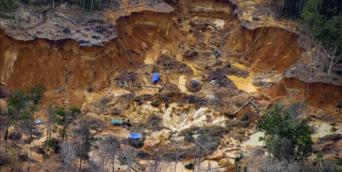 Área degradada por garimpo ilegal no rio Uraricoera, em território Yanomami, com impactos ambientais ligados à atuação de facções na Amazônia.